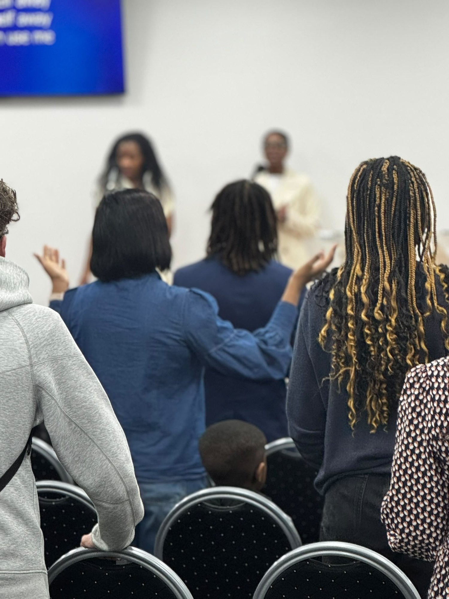 People worshipping together at Potters House Derby